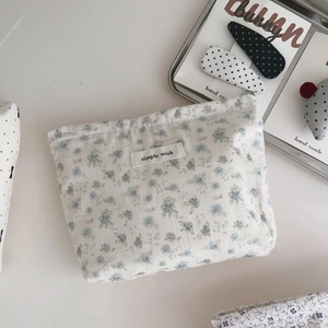Macro detail of cotton floral cosmetic bag with simple wish label and zipper