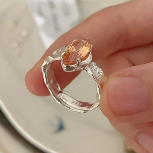 925 sterling silver ring featuring a marquise-cut orange zircon and textured band