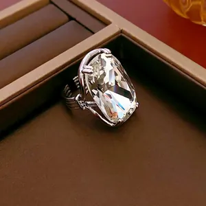 Luxury geometric silver ring with a large rectangular crystal in a brown leather box