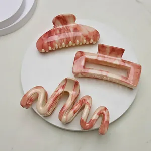 Three-piece marble pattern hair claw clips set in pink and white acetate for women