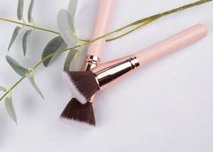 Flat top foundation brushes with pink handles and rose gold metal tubes in detail