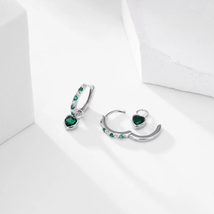 Detail of silver heart earrings with green gemstone and micro-pave zirconia crystals