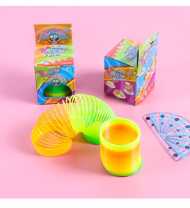 Rainbow spring toy in vibrant gradient colors with cartoon packaging on pink background