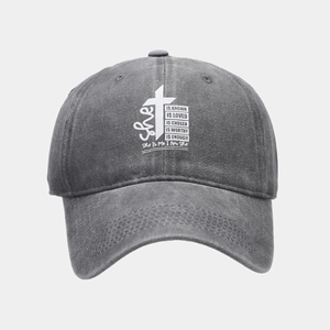 Detail of vintage washed grey cotton baseball cap featuring white graphic text and cross print