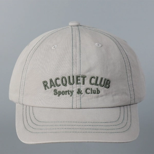 Detail of Racquet Club 3D embroidery and green contrast stitching on a grey baseball cap