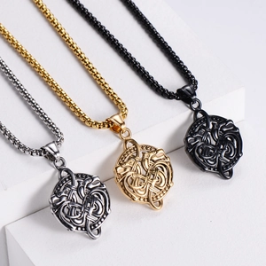 Detailed view of Viking dragon round pendants in gold, silver, and black finishes