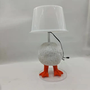 Close-up of novelty resin white chicken lamp with realistic feather texture and power cable