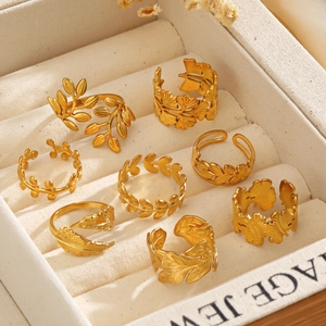 18K gold plated ginkgo leaf and feather adjustable open rings in a vintage jewelry box