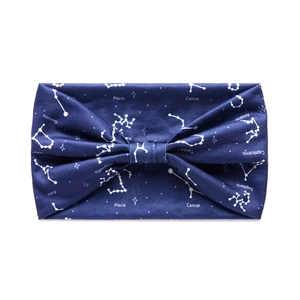 Close-up of dark blue fabric headband featuring white Spanish zodiac constellation patterns