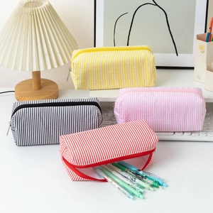 Set of seersucker pencil cases in yellow, pink, black, and red with large capacity