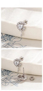 Detail of heart zirconia earring with screw-back design and vintage silver finish