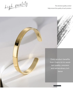 Macro detail of the minimalist polished golden brass open C-shape adjustable bracelet