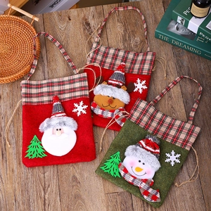 Three Christmas gift bags with Santa, reindeer and snowman in festive plaid fabric
