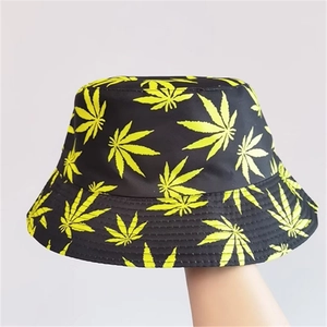 Double-sided sun hat featuring neon yellow cannabis leaf print on black fabric background