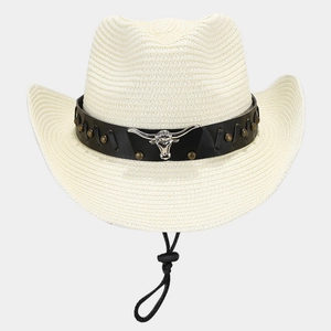Close-up of straw cowboy hat featuring vintage bull head metal ornament and leather band