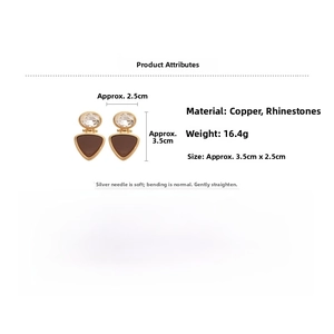 Detail of vintage 18k gold plated triangle drop earrings with cubic zirconia and silver needles