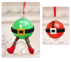 Close-up of creative Christmas clear balls with Santa and Elf legs with glitter