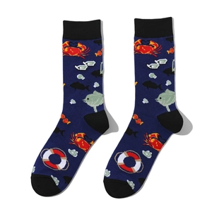Detail of navy cotton crew socks featuring red crab and nautical marine patterns