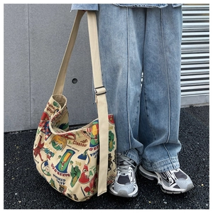 Street style shot of large beige canvas tote bag with retro vintage cartoon prints