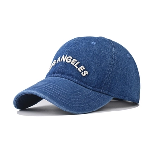 Detail of Los Angeles white 3D embroidery on washed dark blue denim baseball cap