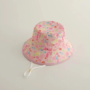 Detailed top view of pink kids sun hat with colorful sea life prints and adjustable cord