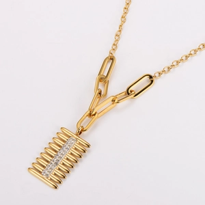 Golden stainless steel comb pendant necklace with clear rhinestones set on white background