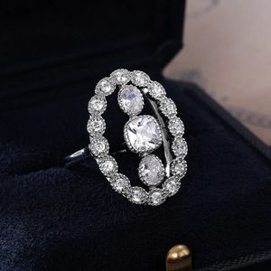 Luxury silver-tone cocktail engagement ring with layered crystals on blue velvet