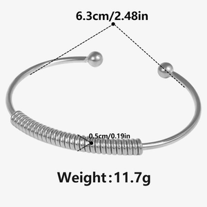 Detail view of silver C-shaped coil bracelet with dimensions 6.3cm and 0.5cm width