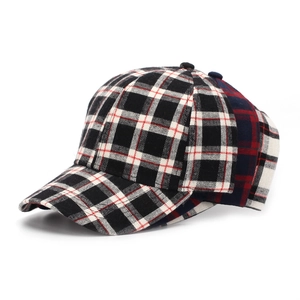 Detailed side view of stacked plaid baseball caps in various colors with curved brims