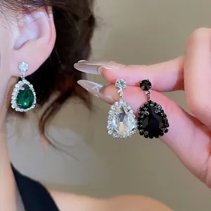 Elegant teardrop earring set with emerald green crystals and sparkling rhinestone borders