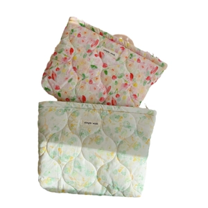 Quilted floral makeup bag set in pink and green cotton fabric with zipper closure