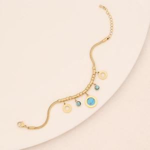 Detail of gold snake chain bracelet with turquoise charms and Roman numeral engravings