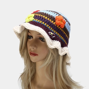 Close-up of handmade crochet bucket hat featuring colorful stripes and floral details