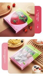 Detail of strawberry-themed kids' flatware set with silicone handles and stainless steel tips