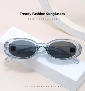 Detail of light blue oval sunglasses on display featuring UV protection lens technology