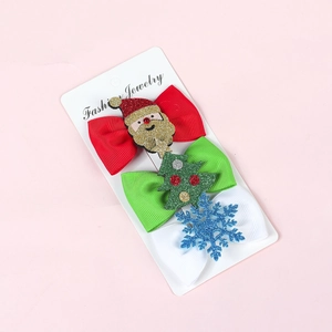 Three-piece Christmas bow hair clip set with Santa, tree, and snowflake patterns