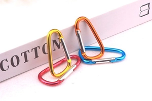 Colorful D-shaped aluminum carabiners in yellow, orange, blue, and red for outdoor use