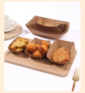 Brown kraft paper food trays in various sizes filled with snacks on a wooden platter