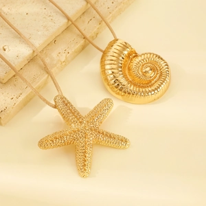 Detail of gold starfish and conch shell pendants on beige woven rope necklaces