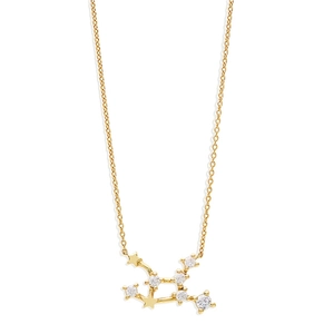 Detailed close-up of gold constellation pendant necklace with zircon stars on fine chain