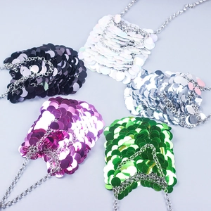 Flat lay view of mini sequin chain bags in black, white, silver, purple, and green colors