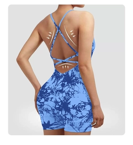 Detail of cross back straps on tie-dye yoga romper with shaping support arrow