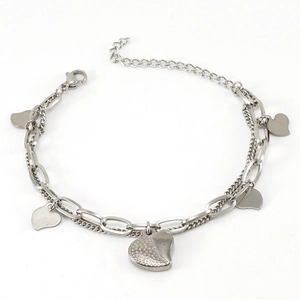 Detail of silver double-layered chain bracelet with textured heart charms and lobster clasp
