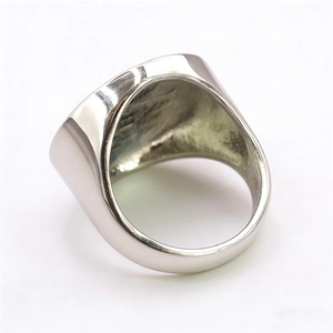 Polished silver stainless steel Eye of Horus signet ring shown from a side-rear angle