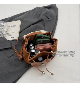 Top view of spacious interior storage for brown shearling bucket backpack and essentials