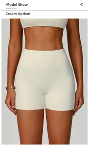 Detail view of high-waisted fitness shorts in cream apricot color with wide waistband
