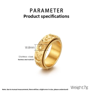Macro shot of 8mm golden stainless steel rotating ring with sun, moon, and star patterns