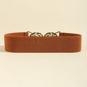 Detail of elastic waist belt with ornate bronze crane buckle on woven brown fabric