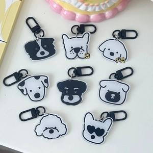 Flat lay of 8 distinct hand-drawn acrylic dog charms with black metal carabiners