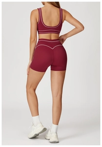 Detail view of wine red yoga set with white contrast trim and racerback sports bra design
